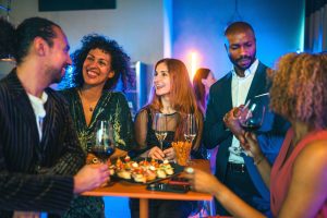 Group of women and men at reception social with wine and food