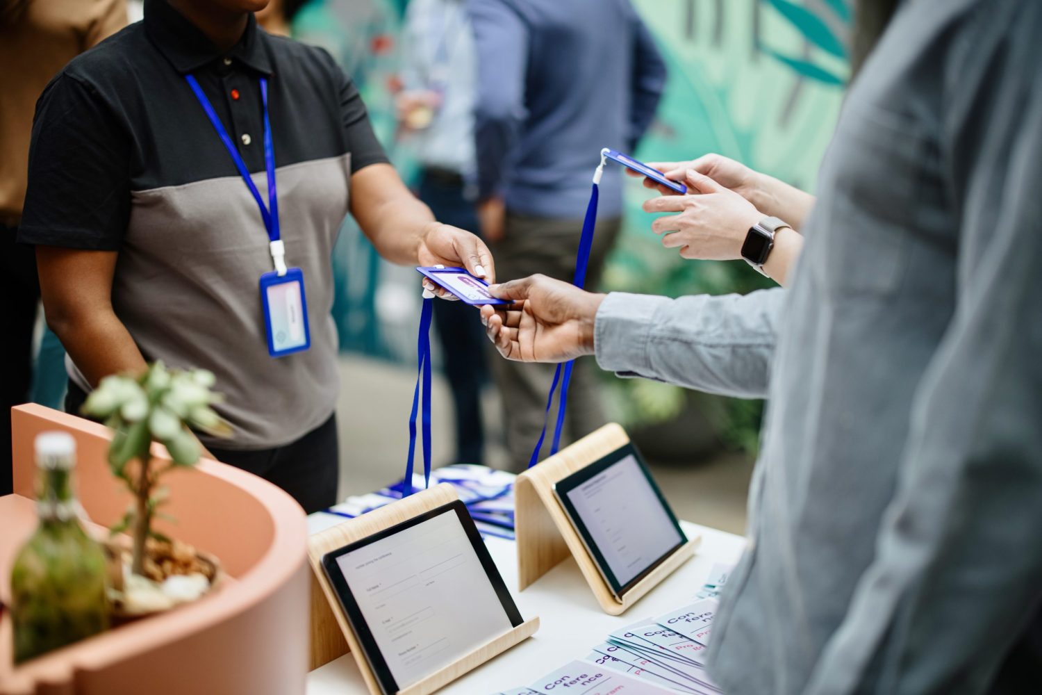 Female staff handing out accreditation to attendees